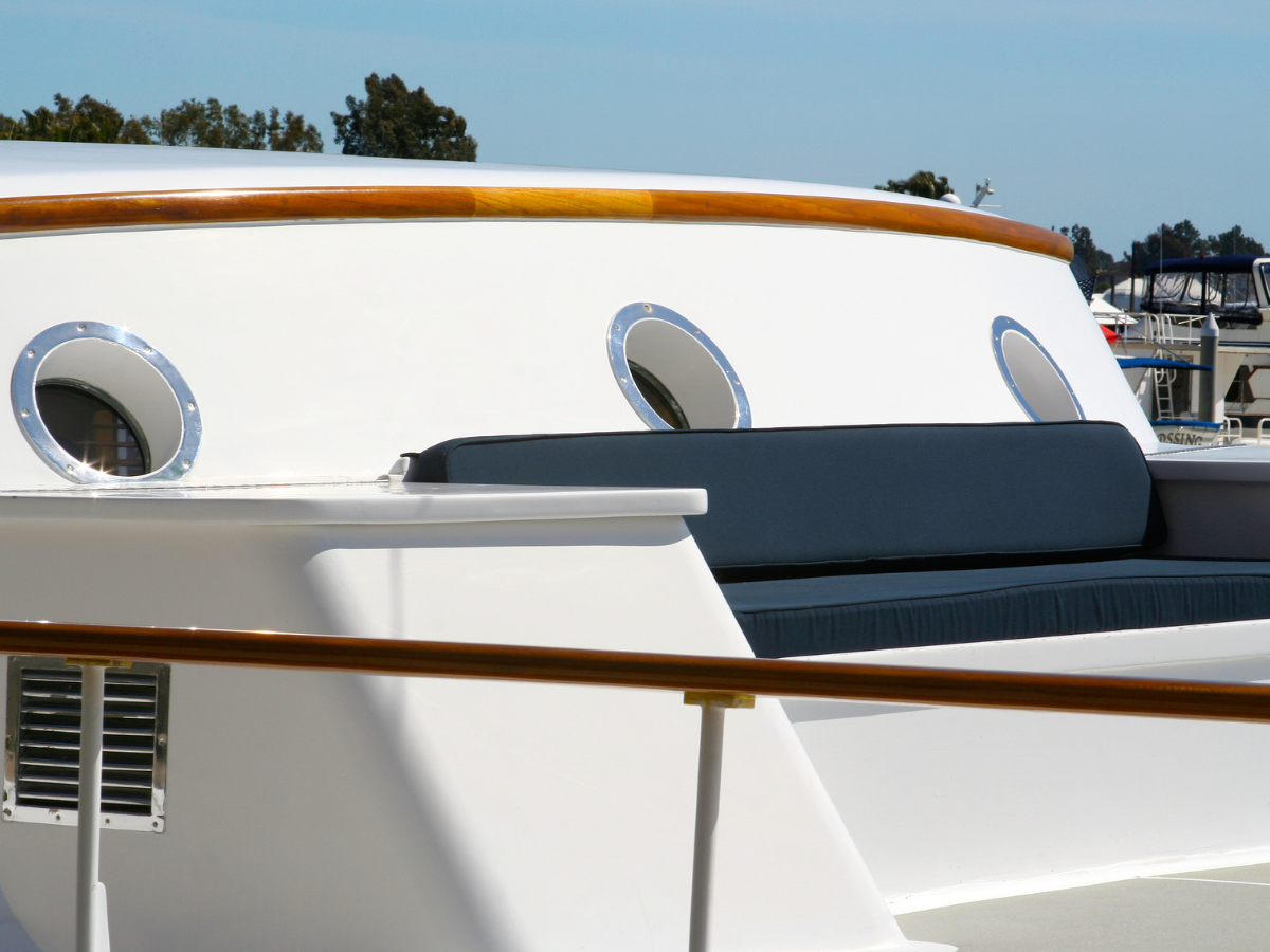 Freshly detailed yacht with polished white gel coat and teak trim